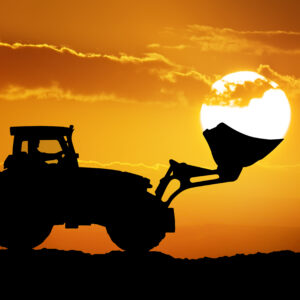 Tractor and sun into shovel bucket.