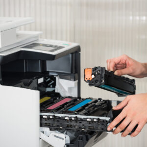 Businessman Fixing Cartridge In Printer Machine At Office